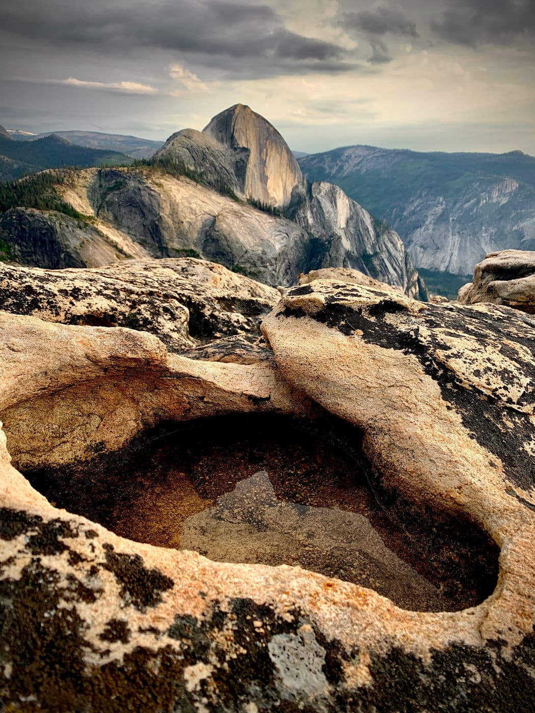 A shot of Half Dome from an angle you don't usually see. This is from Mt. Watkins with a forground granite pothole filled with water from a recent storm.